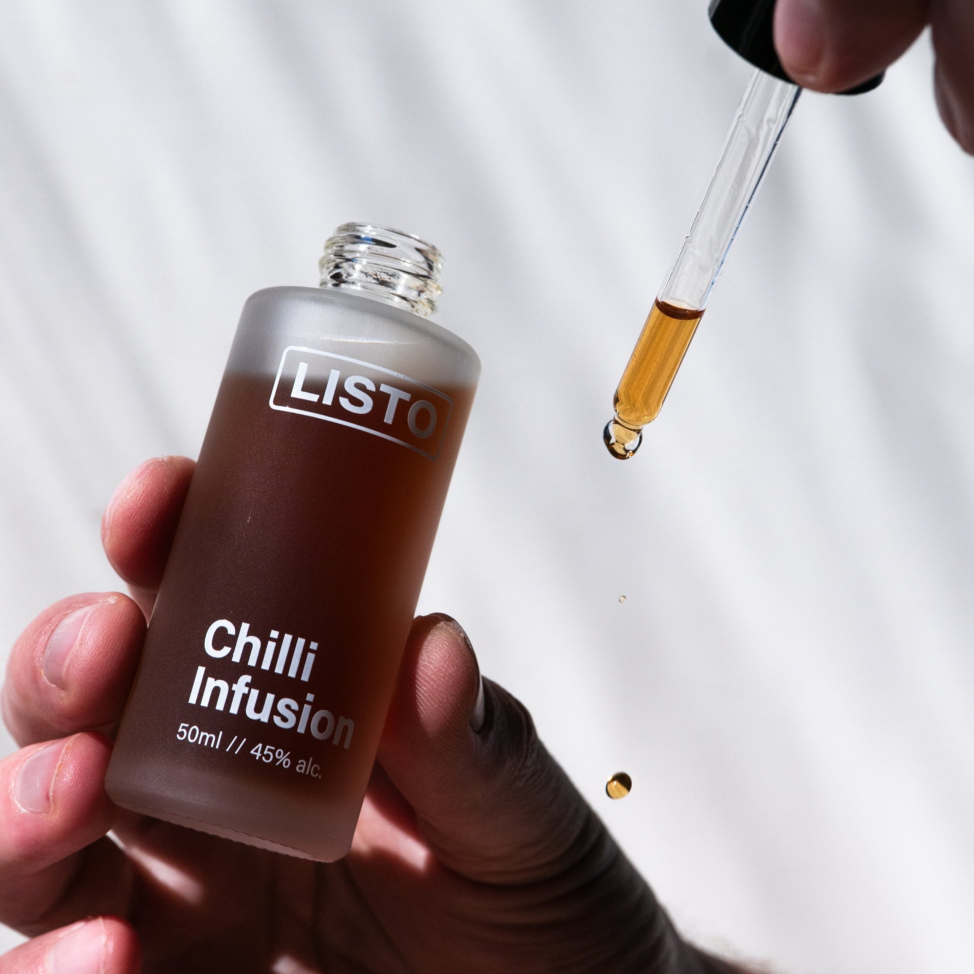 Bottle of LISTO Chilli Infusion with a dropper being used on a white background